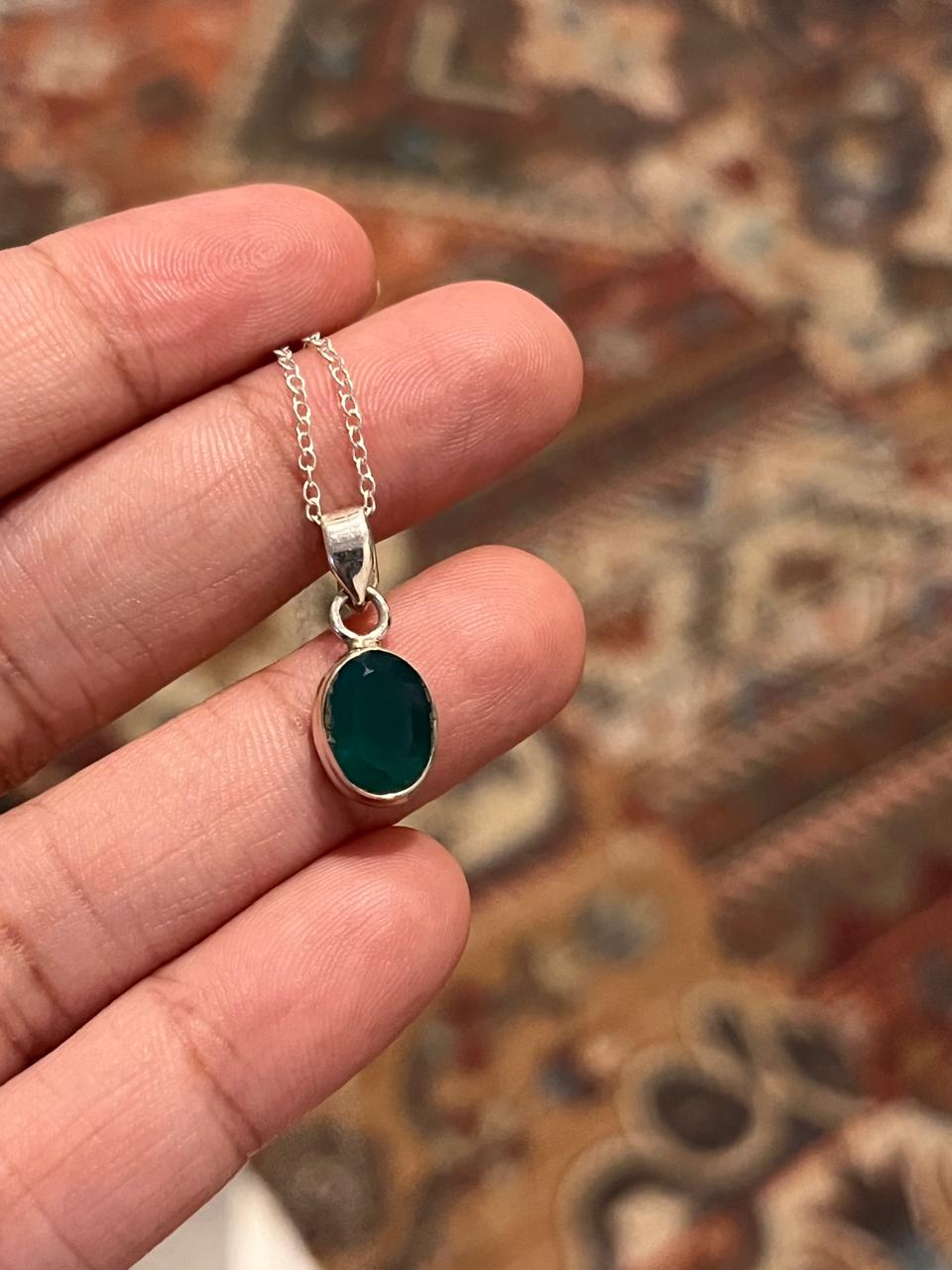 Sterling silver pendant featuring a green onyx oval stone