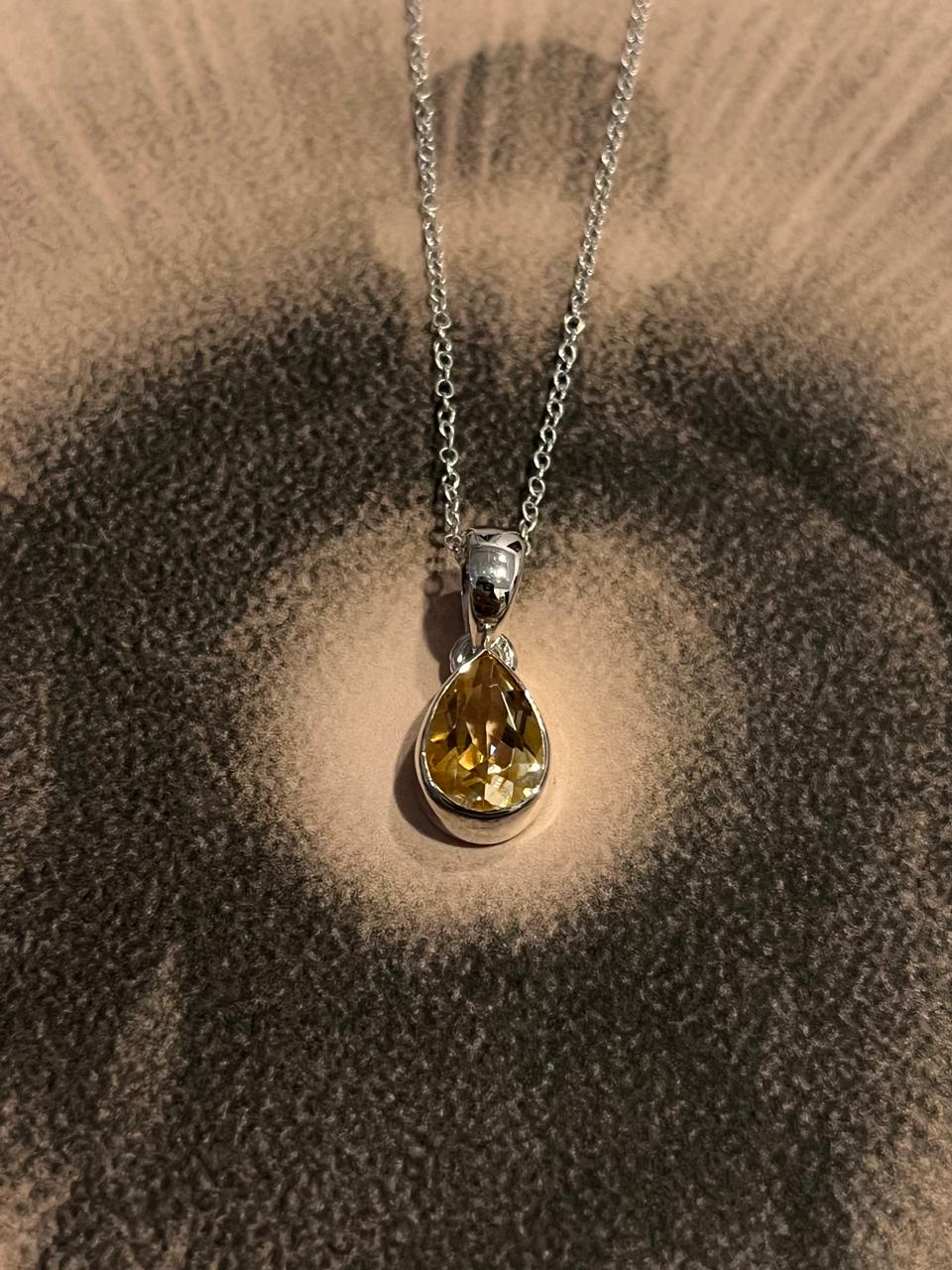Elegant pear cut citrine stone set in a fine silver pendant