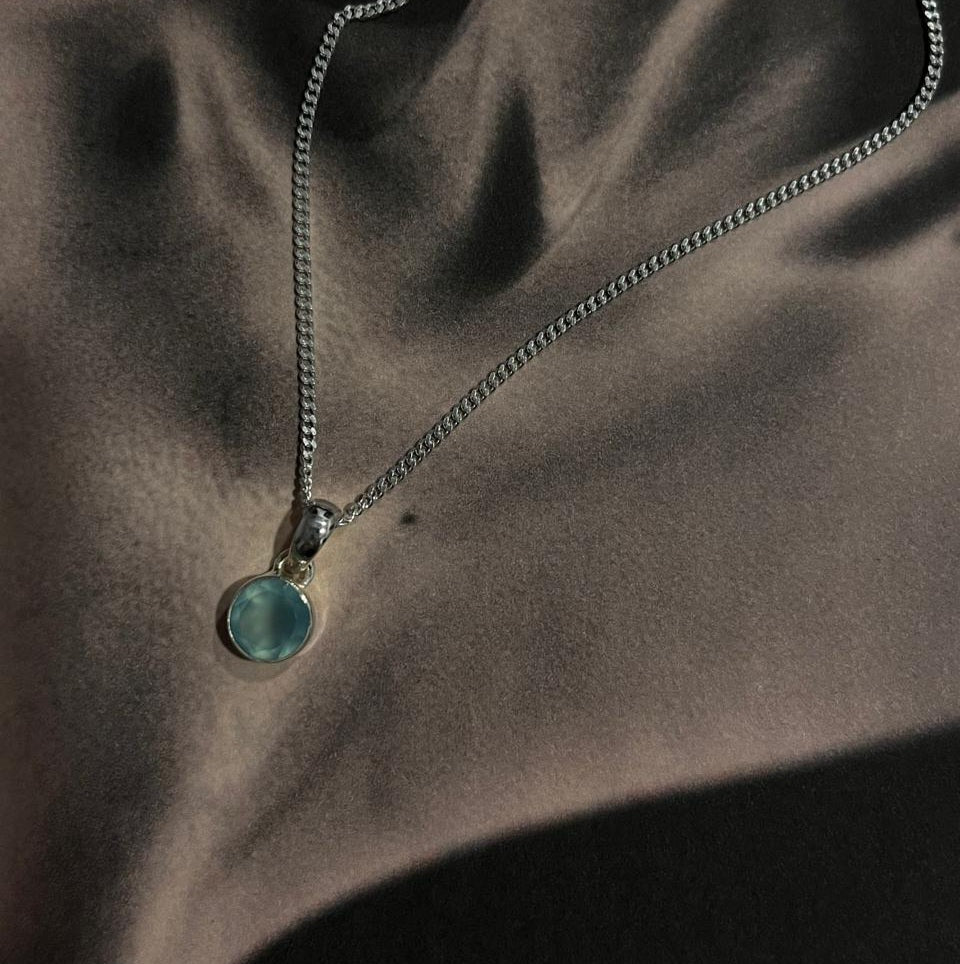 Sophisticated silver pendant with a vibrant round aqua chalcedony gemstone.