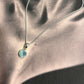 Round aqua chalcedony pendant with sterling silver setting.