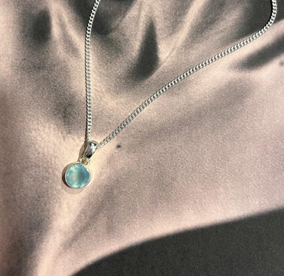 Round aqua chalcedony pendant with sterling silver setting.