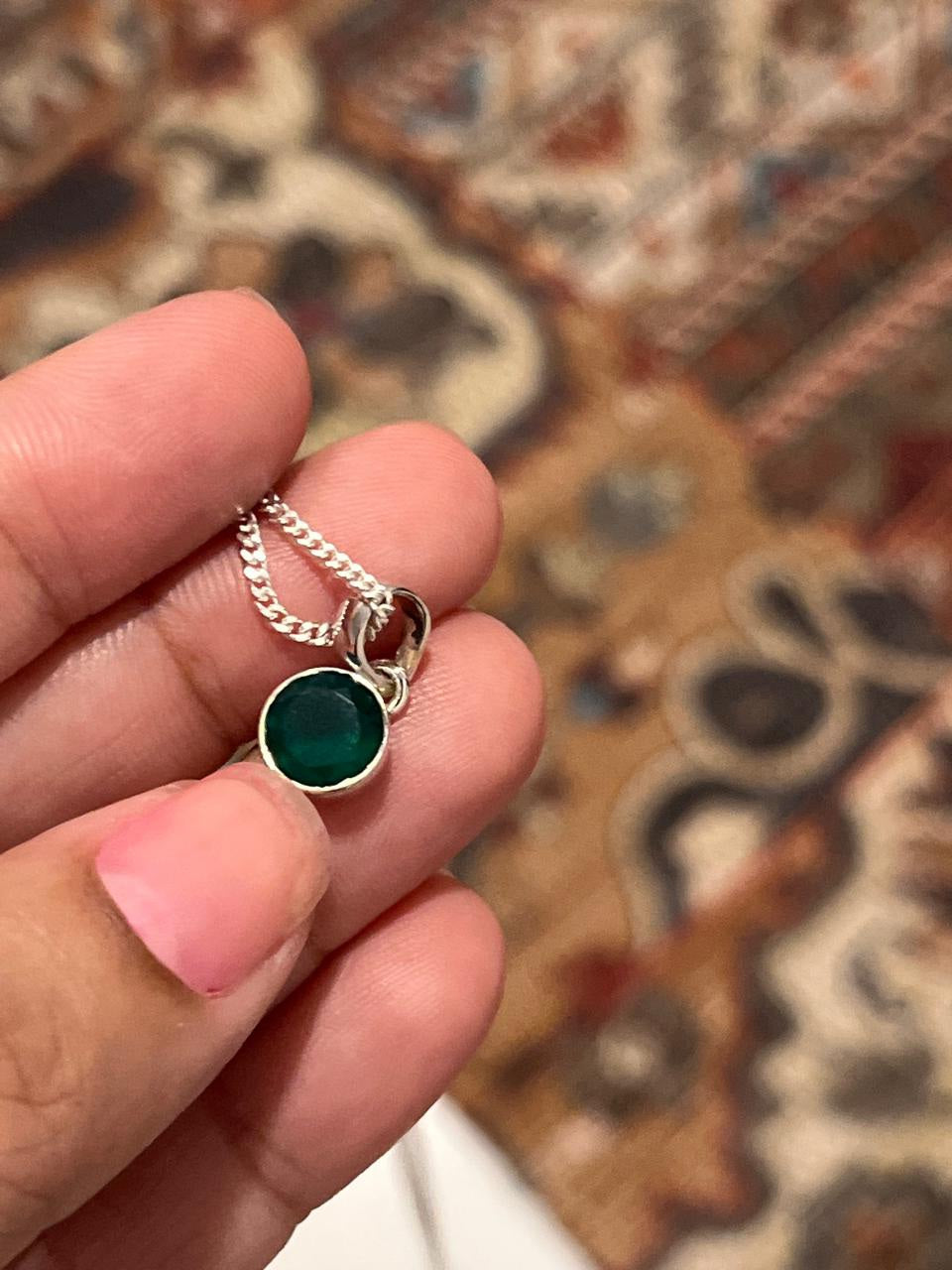 Sterling silver pendant featuring a round cut green onyx stone