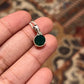 Sleek round cut green onyx pendant with a polished silver setting