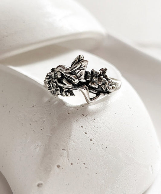 Enchanting fairy in the garden silver ring with intricate floral design