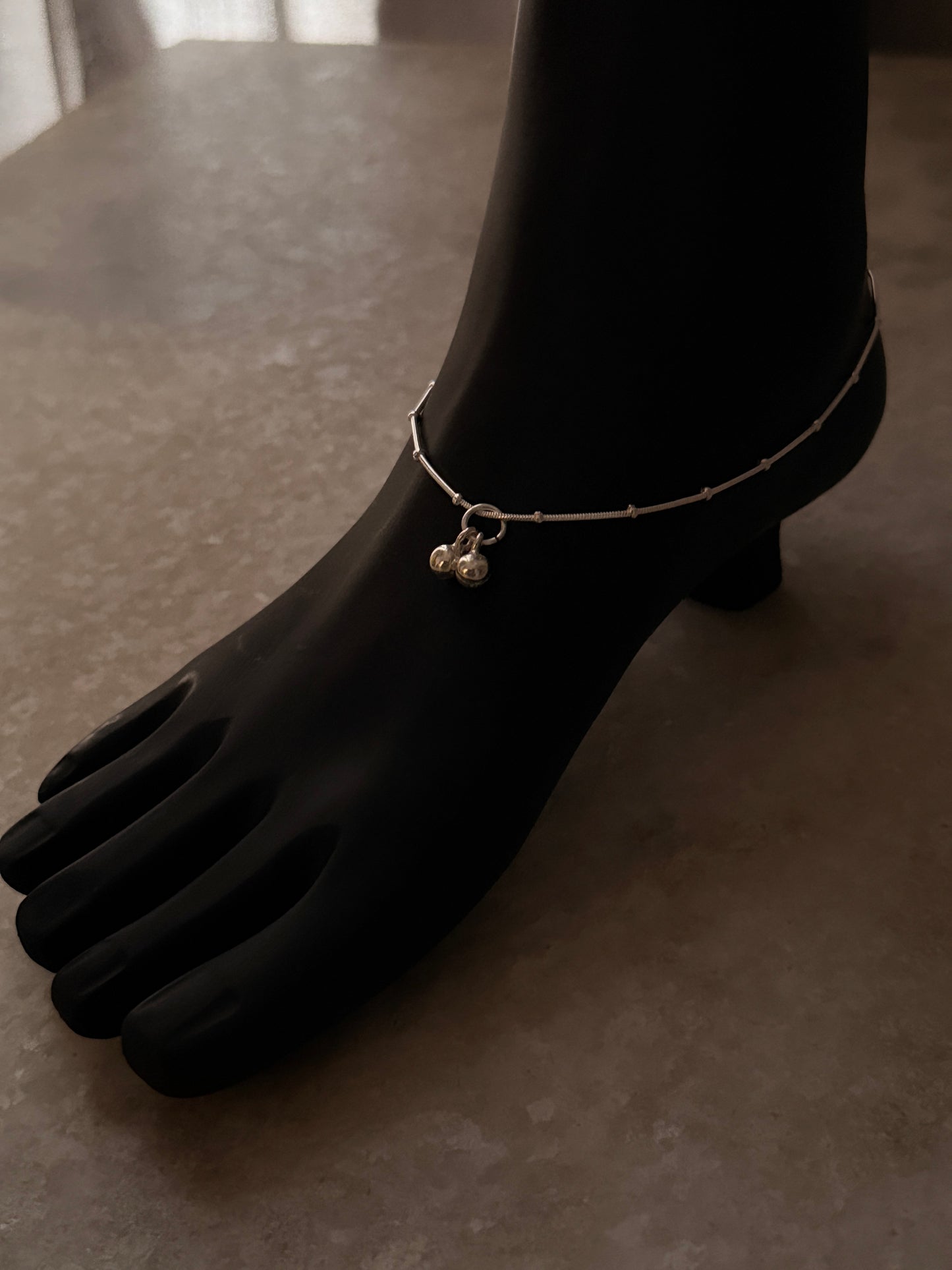Modern silver anklet with intricate snake dot design  