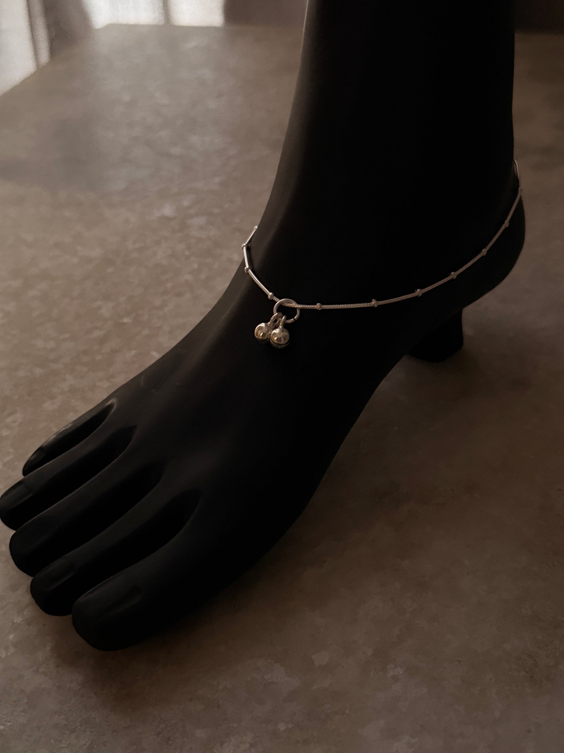 Modern silver anklet with intricate snake dot design  