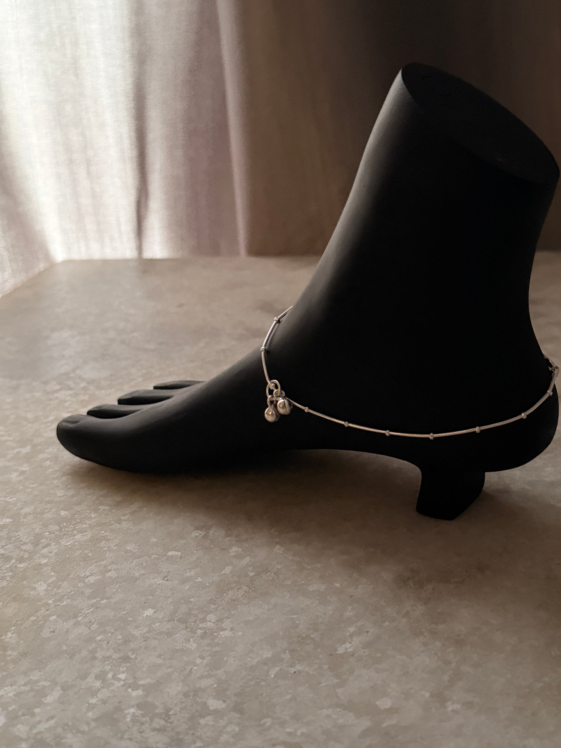 Polished silver anklet featuring snake dot detailing