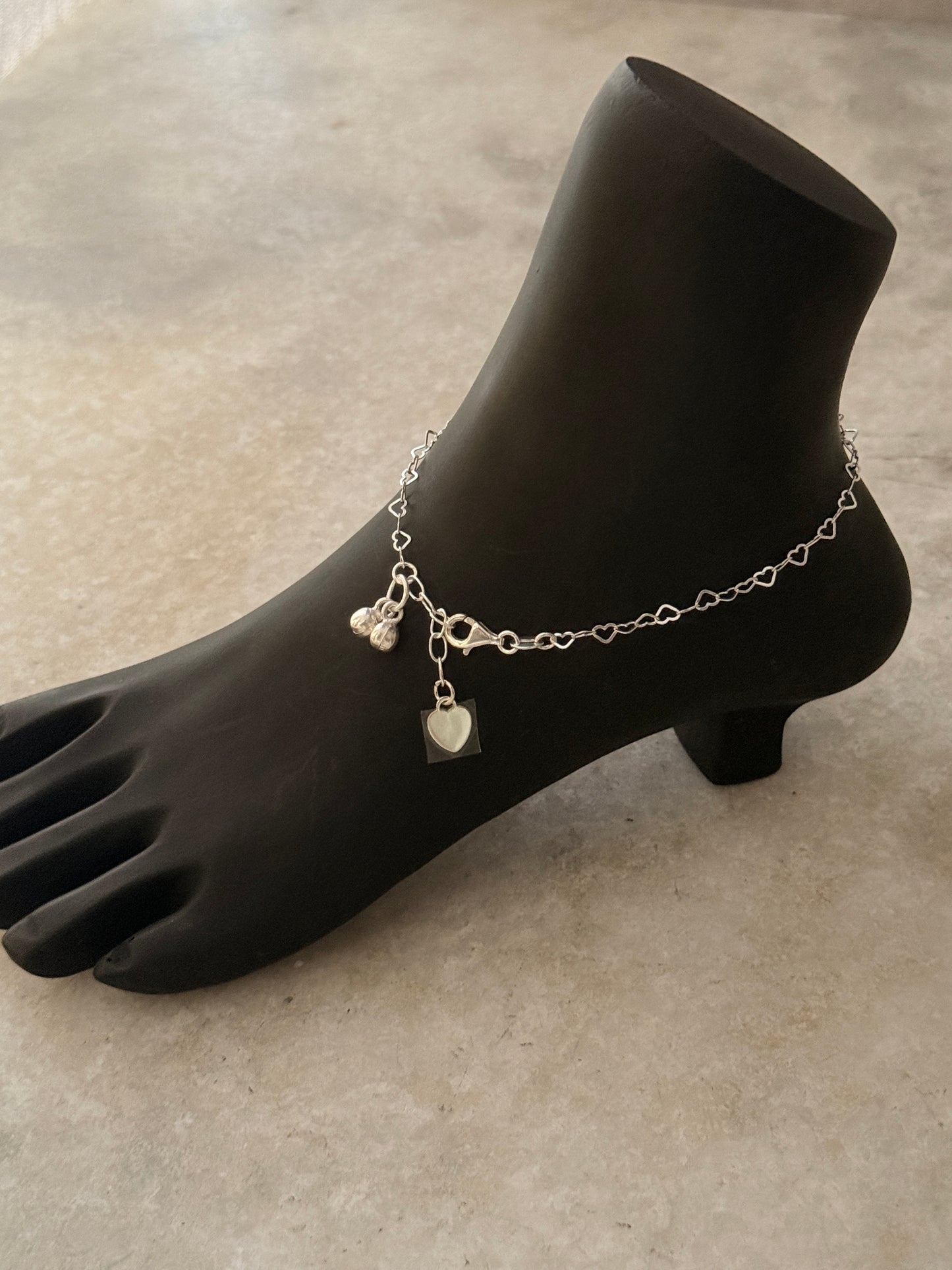 Elegant sterling silver anklet featuring heart chain links  