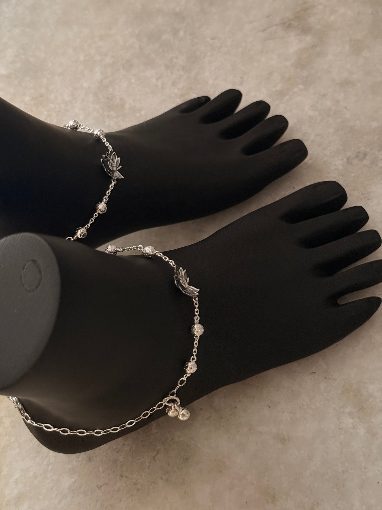 Delicate silver anklet featuring a divine lotus motif  