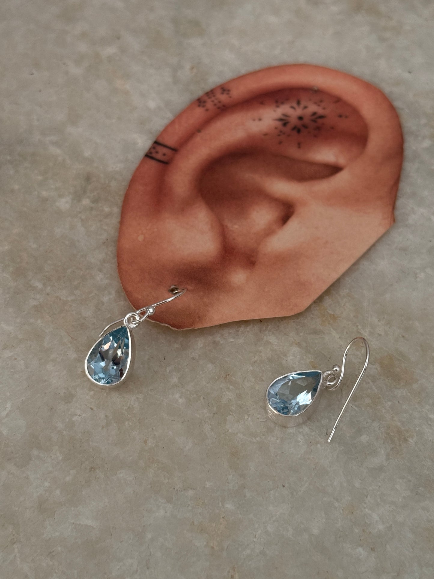 Pear-shaped blue topaz silver earrings in sterling silver