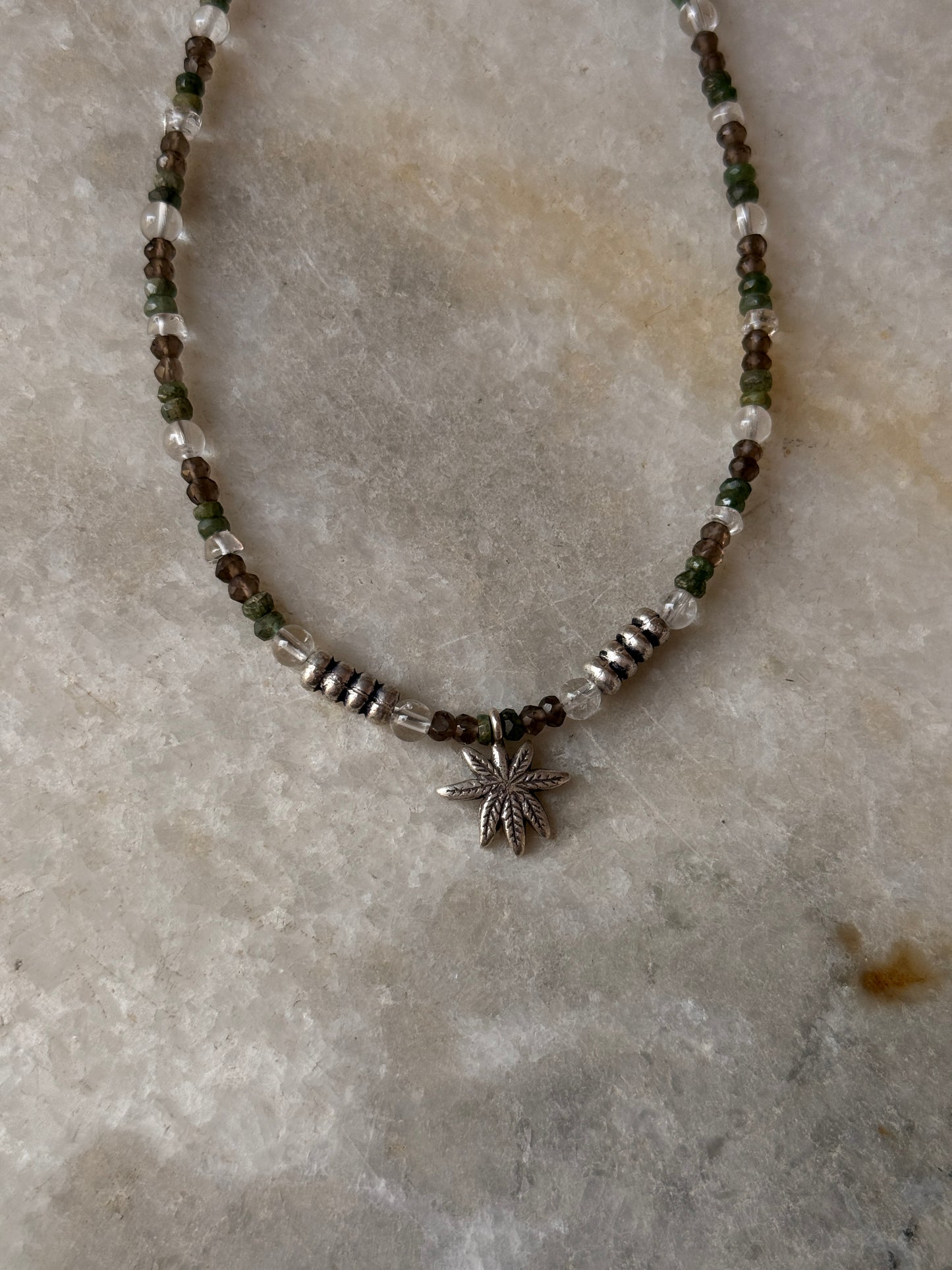 925 Sterling silver artisan necklace with marijuana charm, smokey quartz, and emerald  