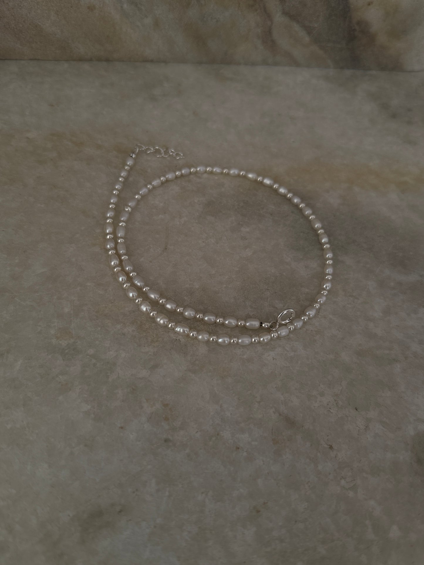 925 Sterling Silver Fresh Water Pearl with 3mm Silver Balls Necklace displayed on a marble surface.