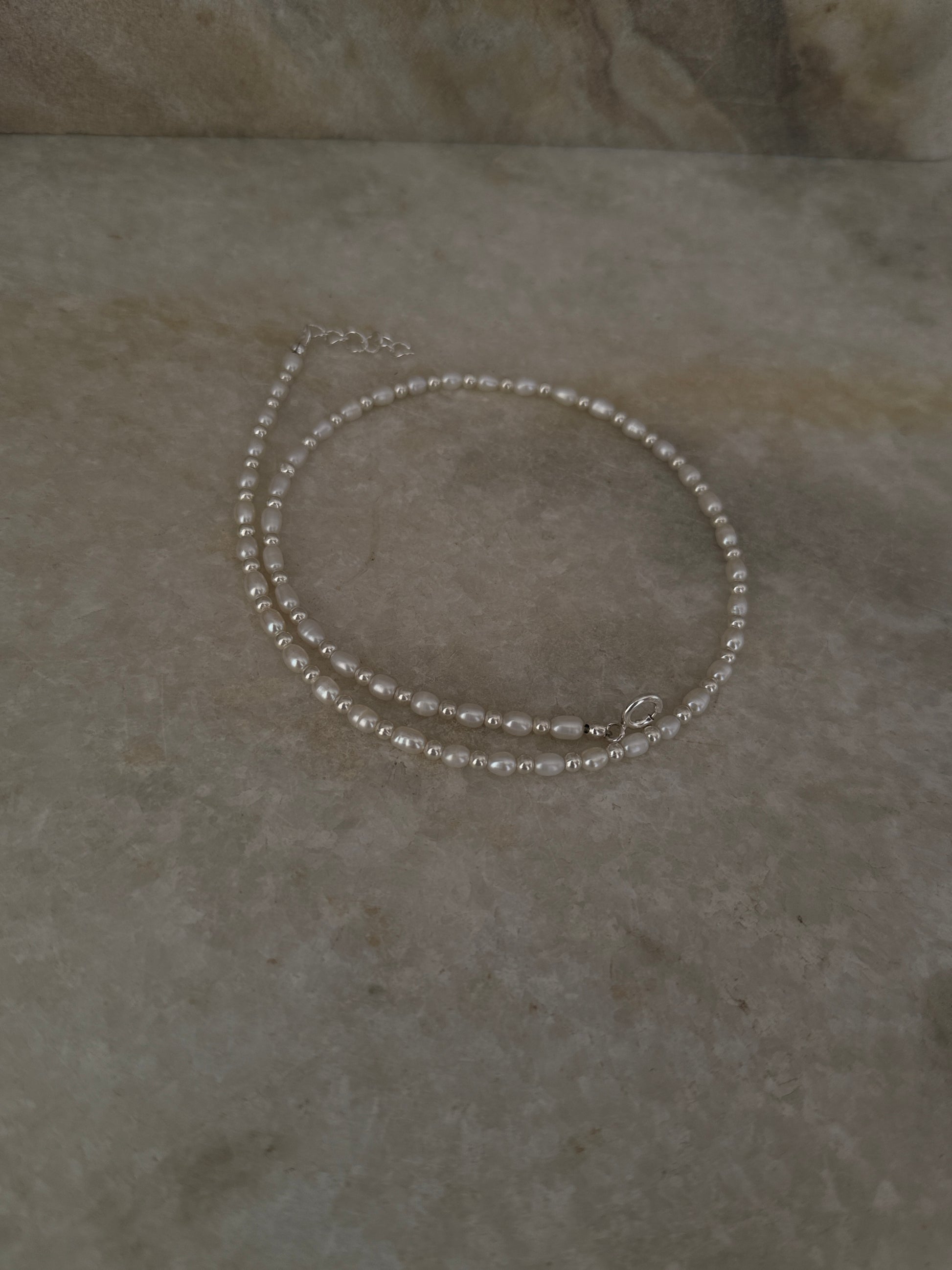 925 Sterling Silver Fresh Water Pearl with 3mm Silver Balls Necklace displayed on a marble surface.