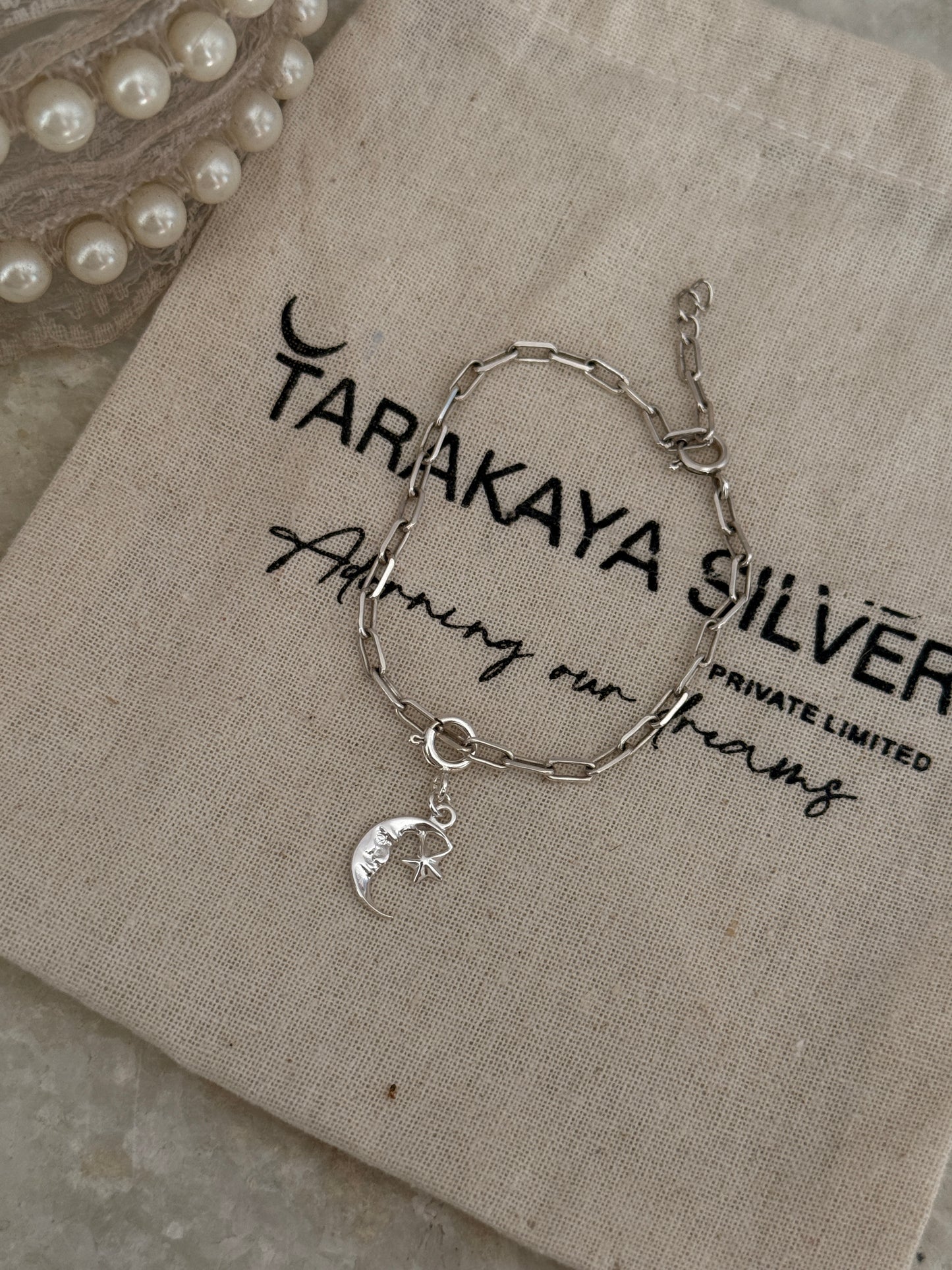 925 sterling silver paper clip bracelet featuring moon and star pendants  