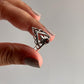 Garnet-studded silver ring with crown and boho elements