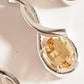 Elegant citrine solitaire stone set in a cross-shaped silver pendant