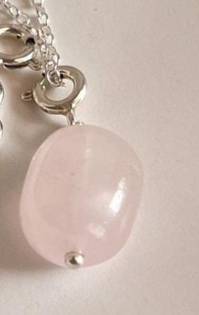 Handcrafted silver pendant featuring a rose quartz tumble charm