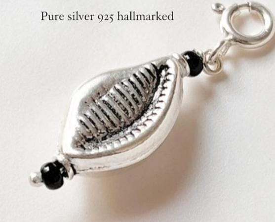 Elegant silver pendant featuring a natural cowrie shell charm