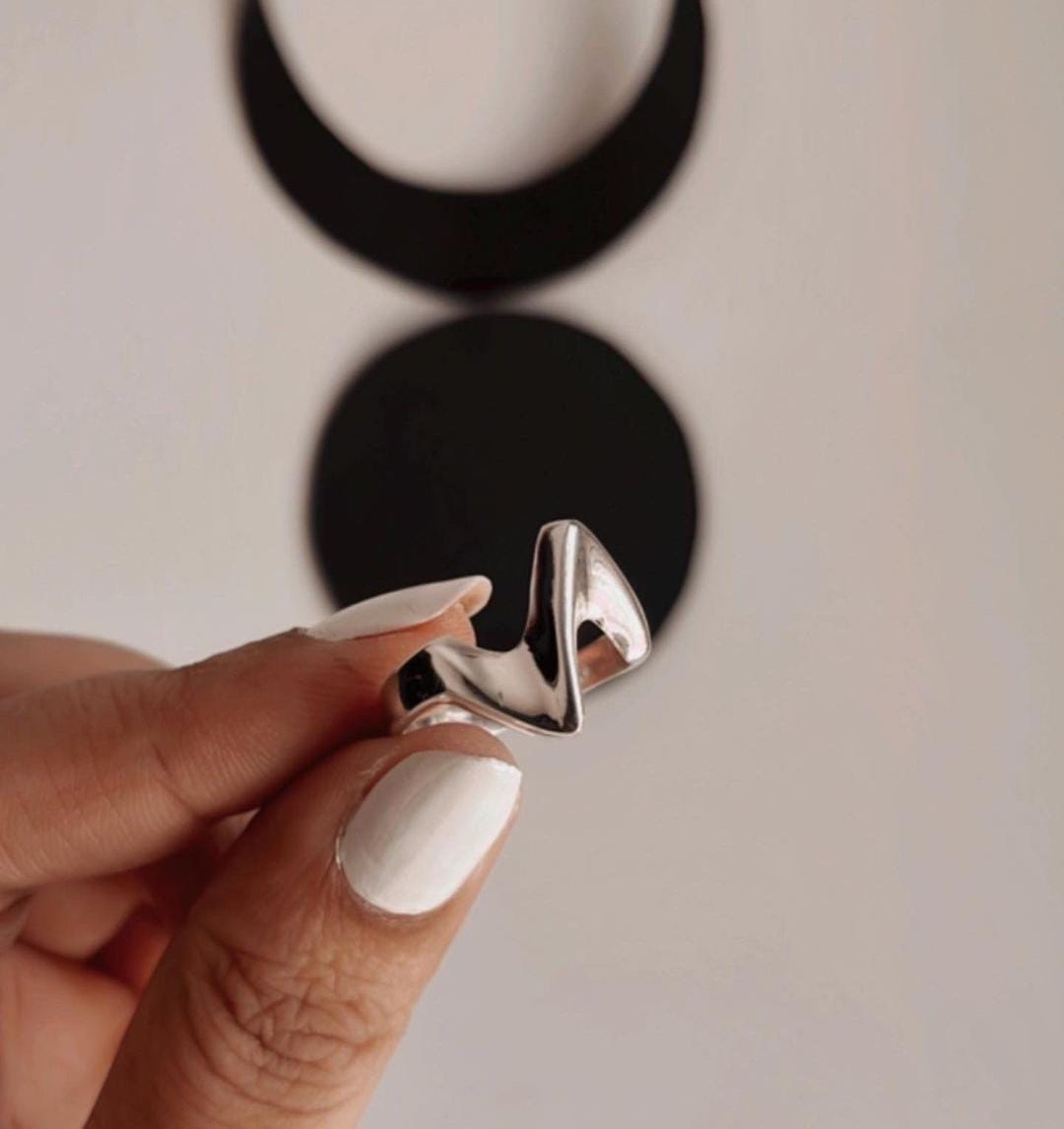 Sterling silver ring featuring abstract sculpture details