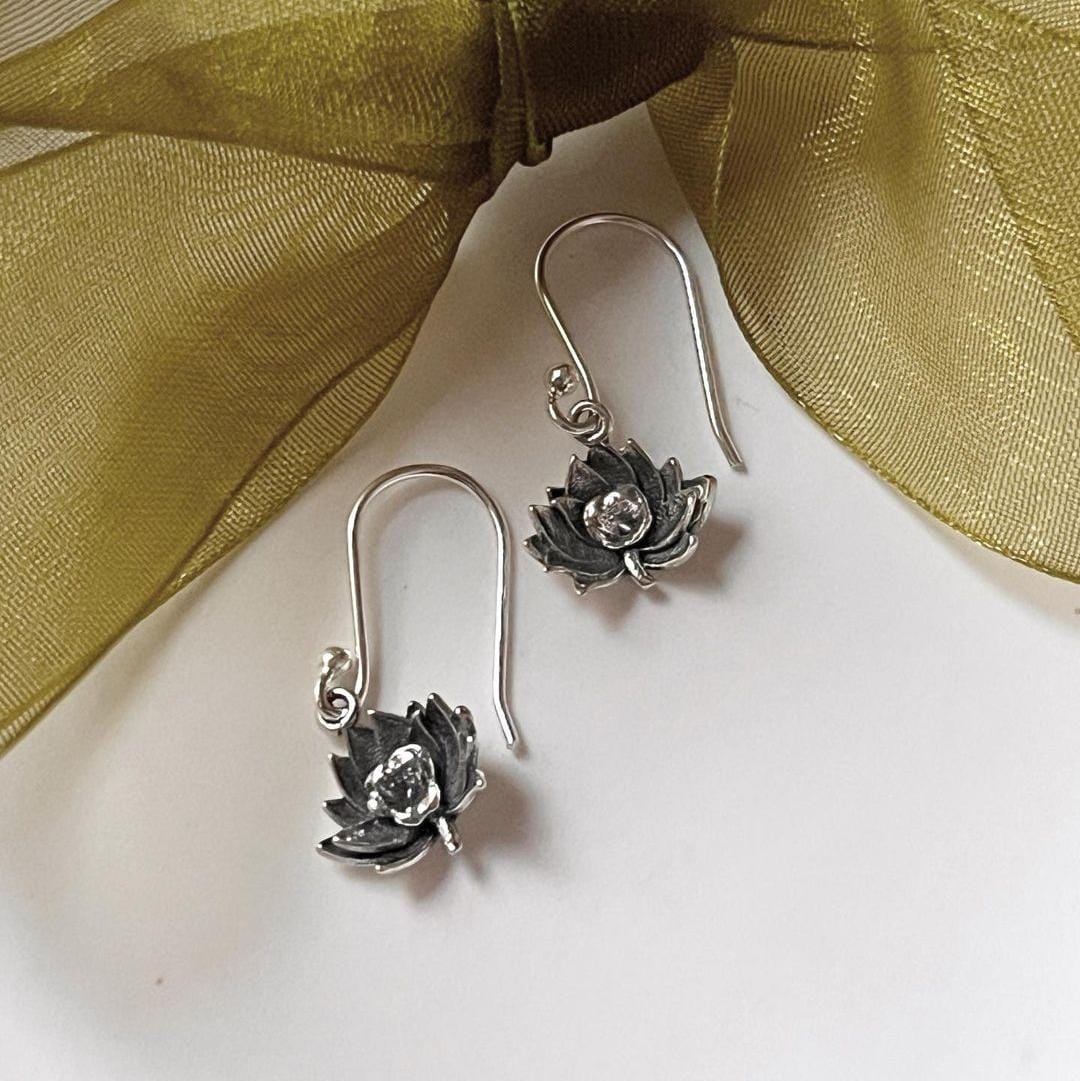 Delicate silver earrings with lotus flower design