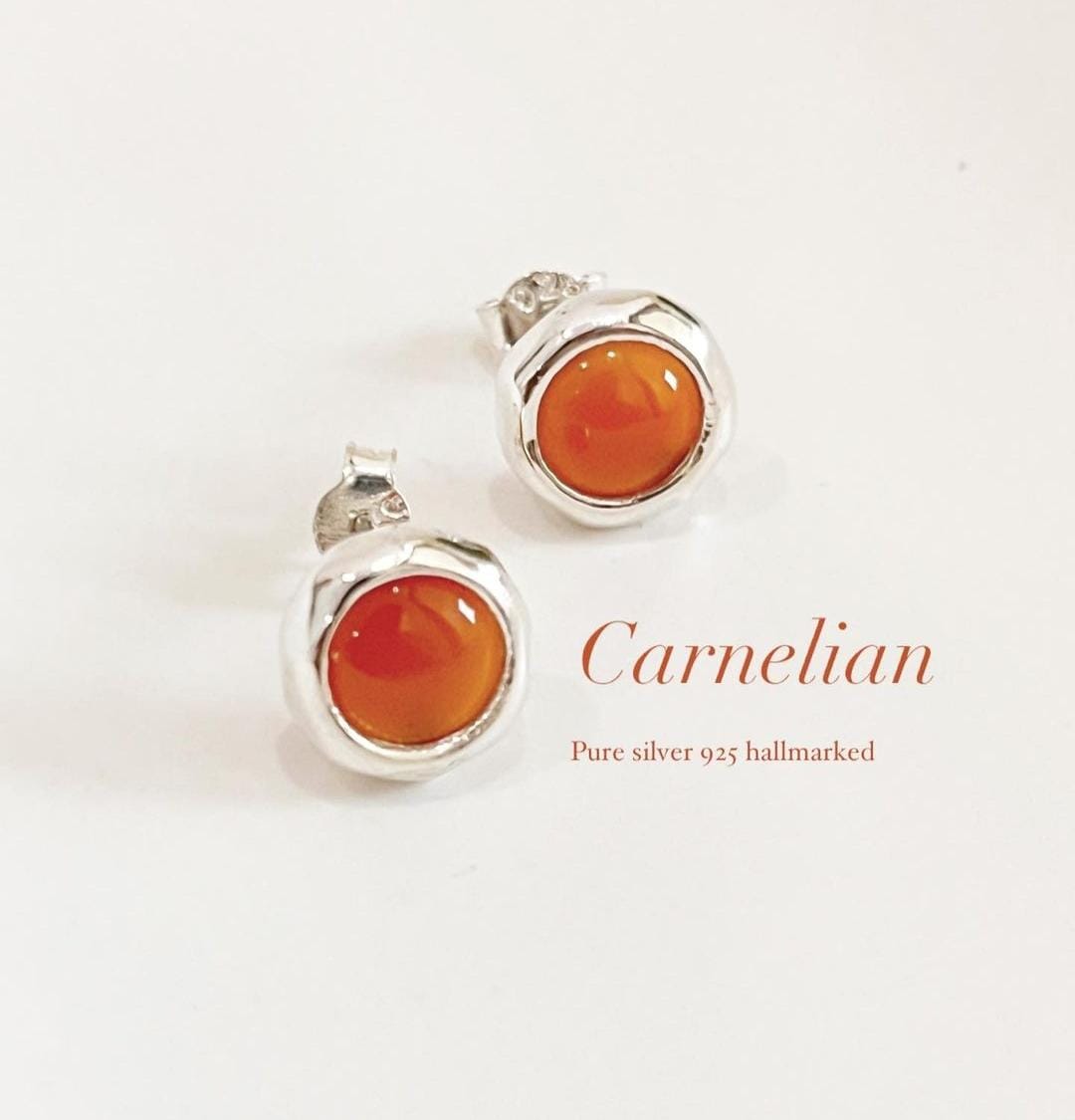 Elegant round carnelian stud earrings with a smooth finish
