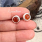 Close-up of carnelian cabochon stone round stud earring
