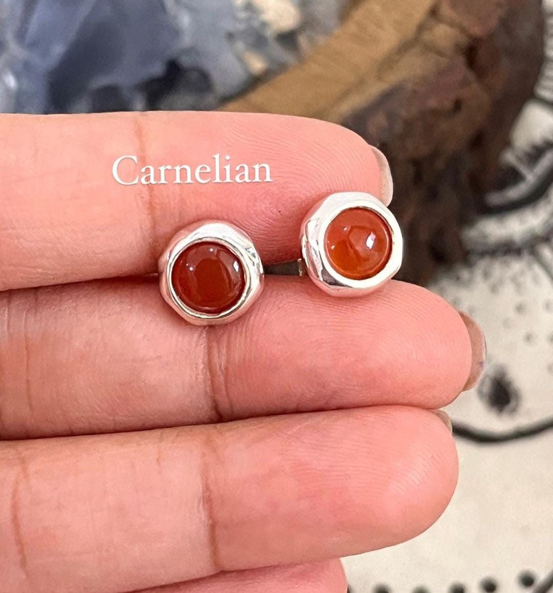 Close-up of carnelian cabochon stone round stud earring