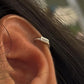 Timeless tiny silver huggies featuring cubic zirconia stones