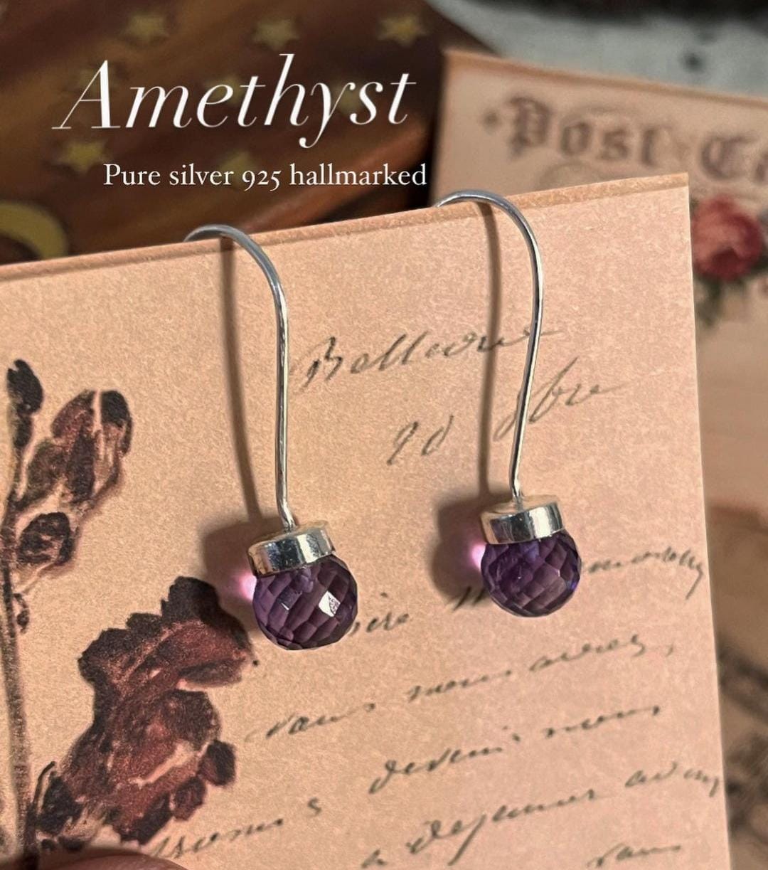 Sleek amethyst round cut hook 925 sterling silver earrings with a modern design.