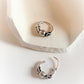 Vintage-inspired silver hoops featuring a detailed design 6.