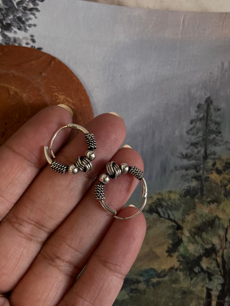 Vintage-inspired silver hoops featuring a detailed design 8.