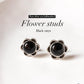 Timeless black onyx flower studs in sterling silver with fine detailing.