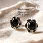 Charming black onyx flower-shaped silver studs for a delicate touch.