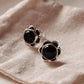 Elegant black onyx flower silver studs with intricate petal design.