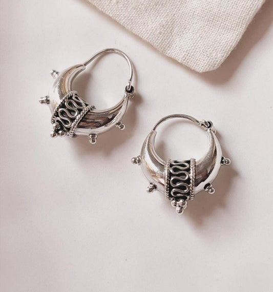 Antique tribal big dolki silver hoop earrings with intricate design.