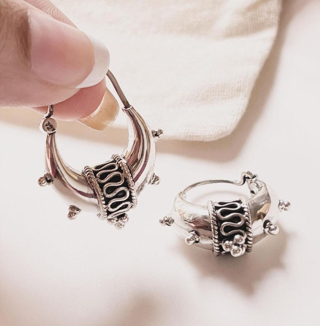 Statement antique tribal silver hoops in a bold dolki style.