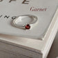 Timeless garnet solitaire ring with a sleek silver band