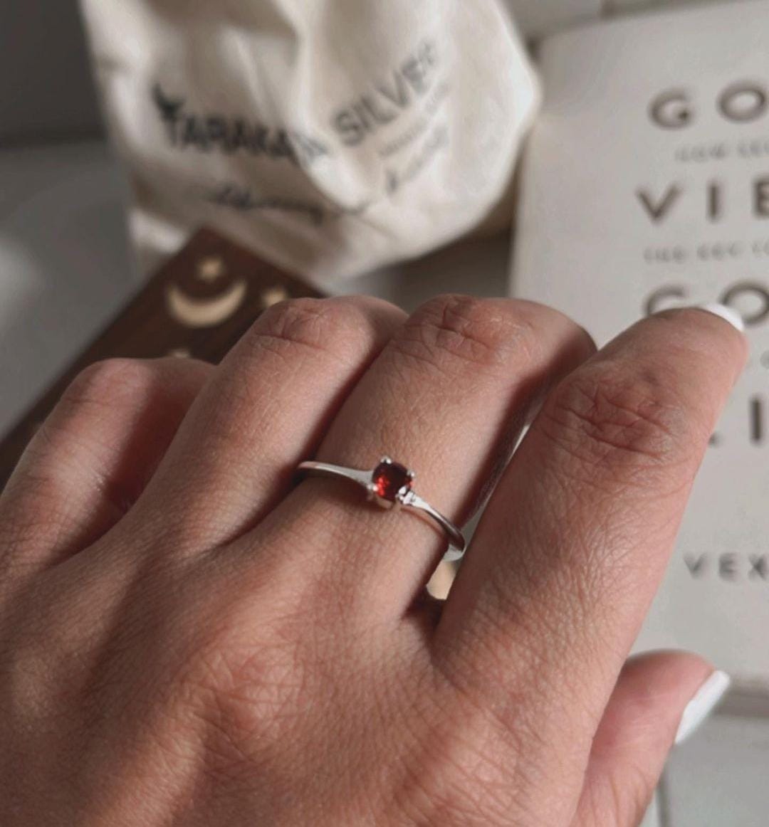 Garnet solitaire gemstone set in a polished silver ring