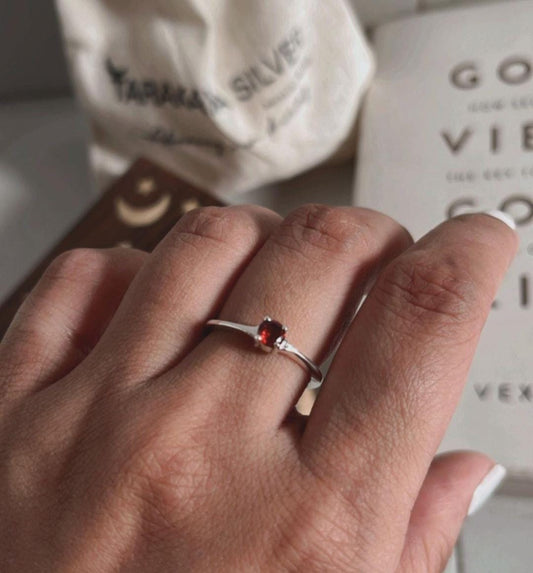 Garnet solitaire gemstone set in a polished silver ring