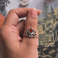 Silver ring featuring a carnelian stone surrounded by lotus petals