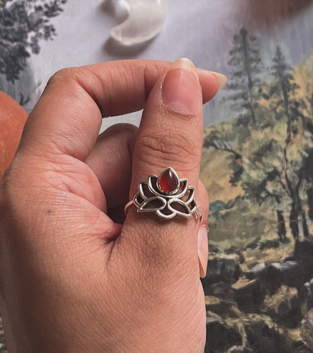 Silver ring featuring a carnelian stone surrounded by lotus petals