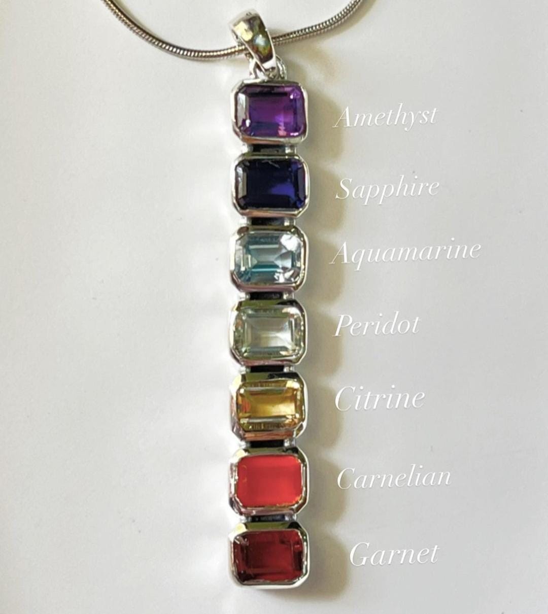 Sterling silver pendant with rectangular cut seven chakra gemstones