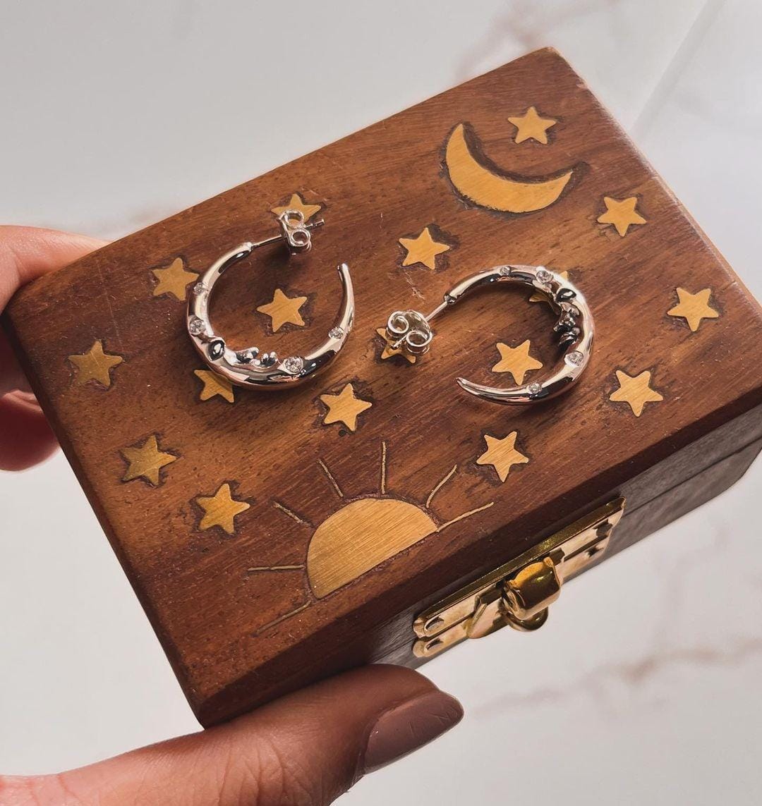 Celestial crescent moon face studded with CZ in sterling silver half hoop design