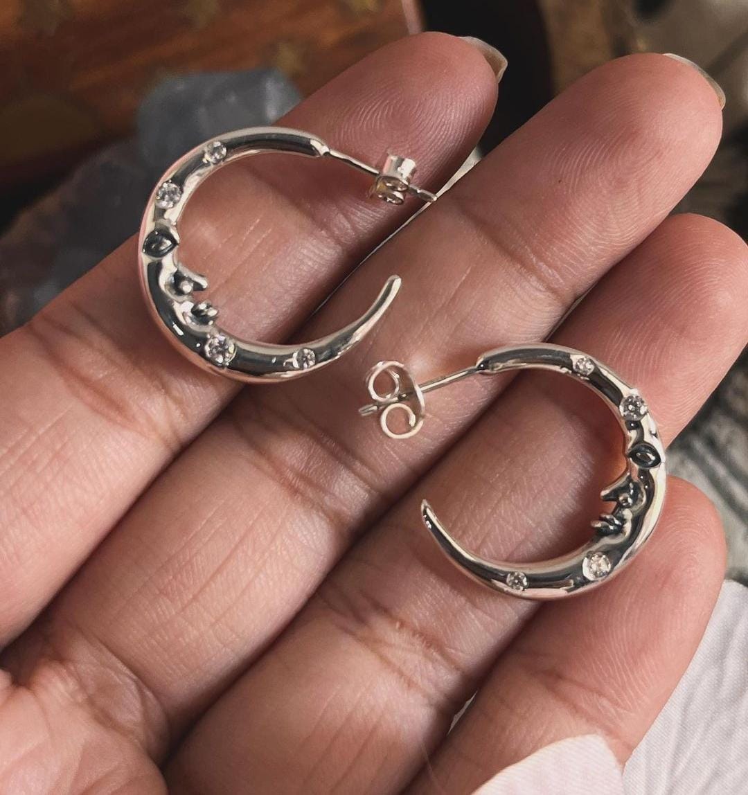 Detailed view of crescent moon face with CZ stones on silver 925 half hoop earrings
