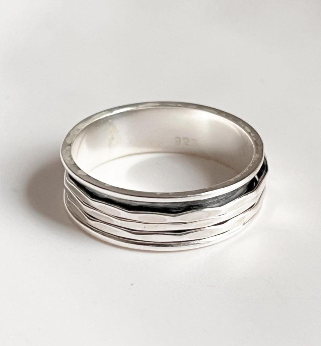 Stylish sterling silver spinner ring with hammered texture