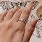 Charming floral spinner silver ring featuring a rotating floral band