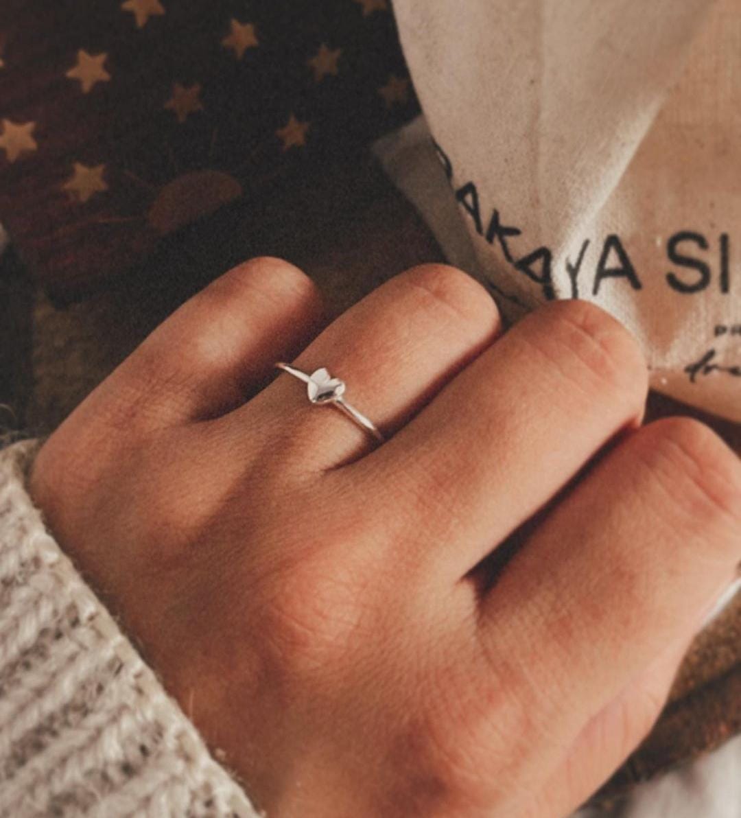 Simple silver ring with tiny heart accent
