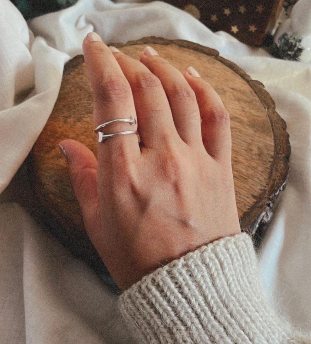 Elegant sterling silver arrow ring with adjustable band.