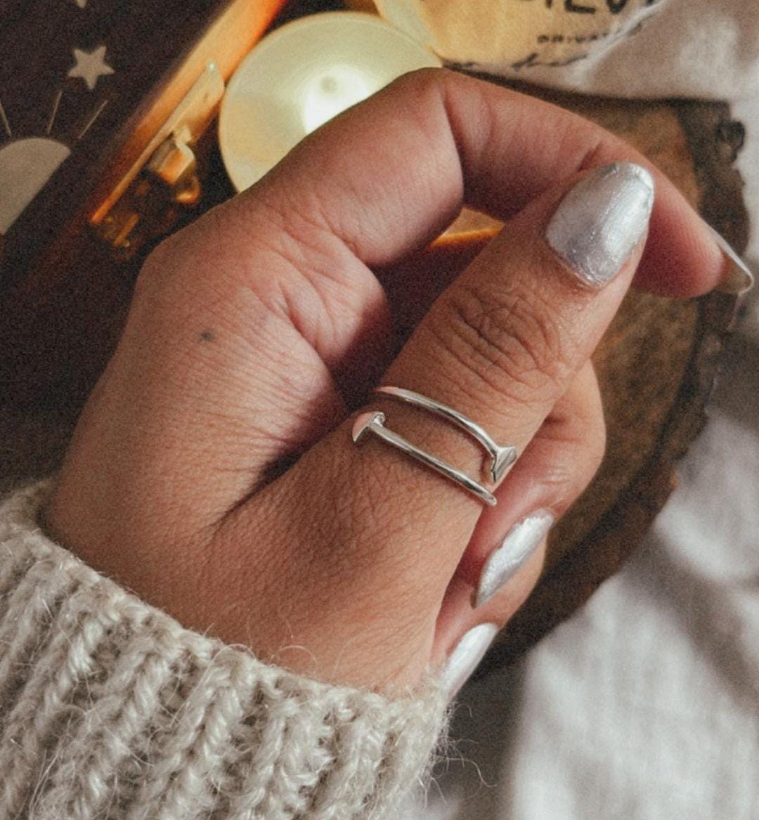 Modern arrow silver ring with an adjustable band for a custom fit.