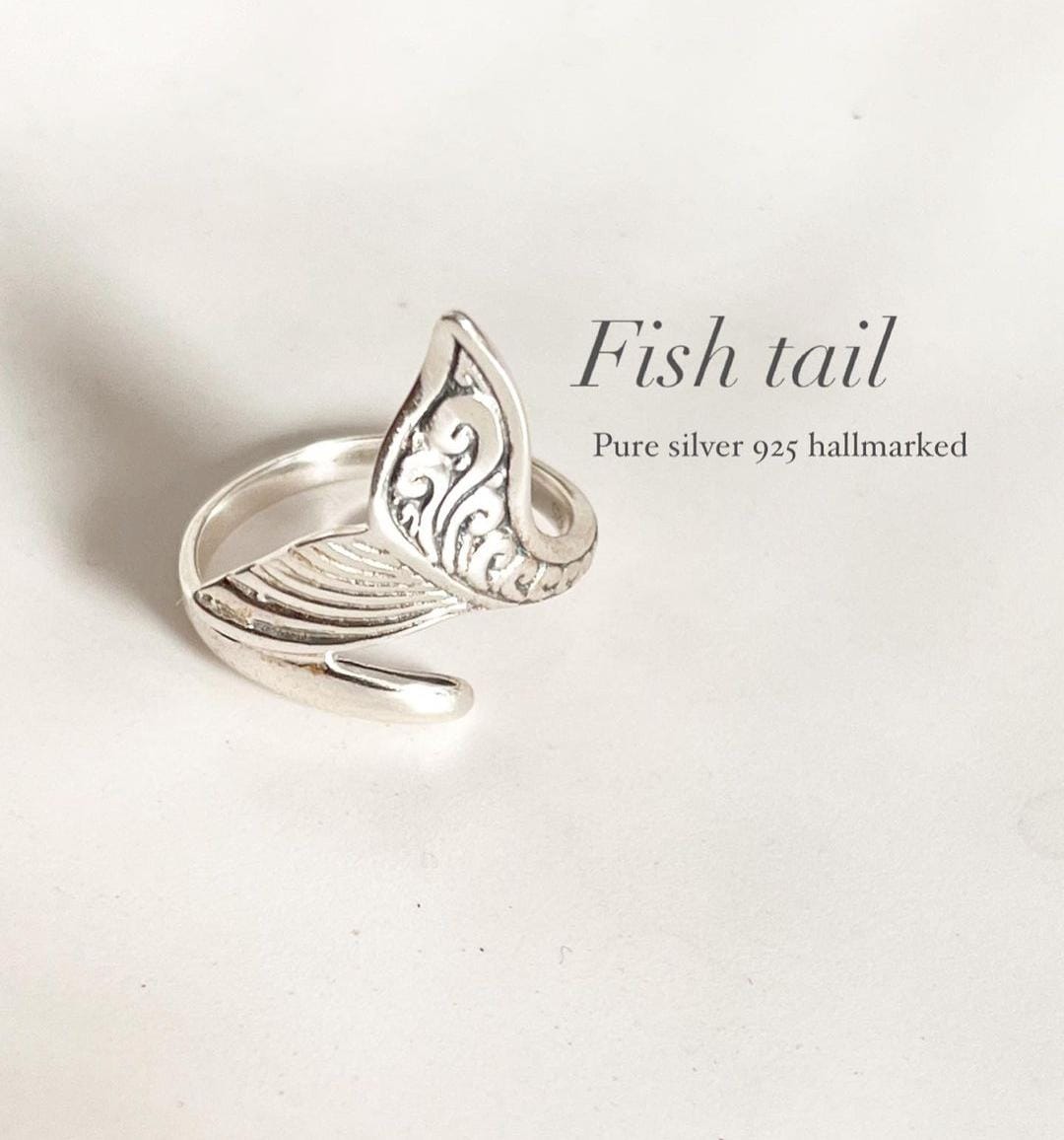 Timeless fish tail silver ring with a flowing, curved shape